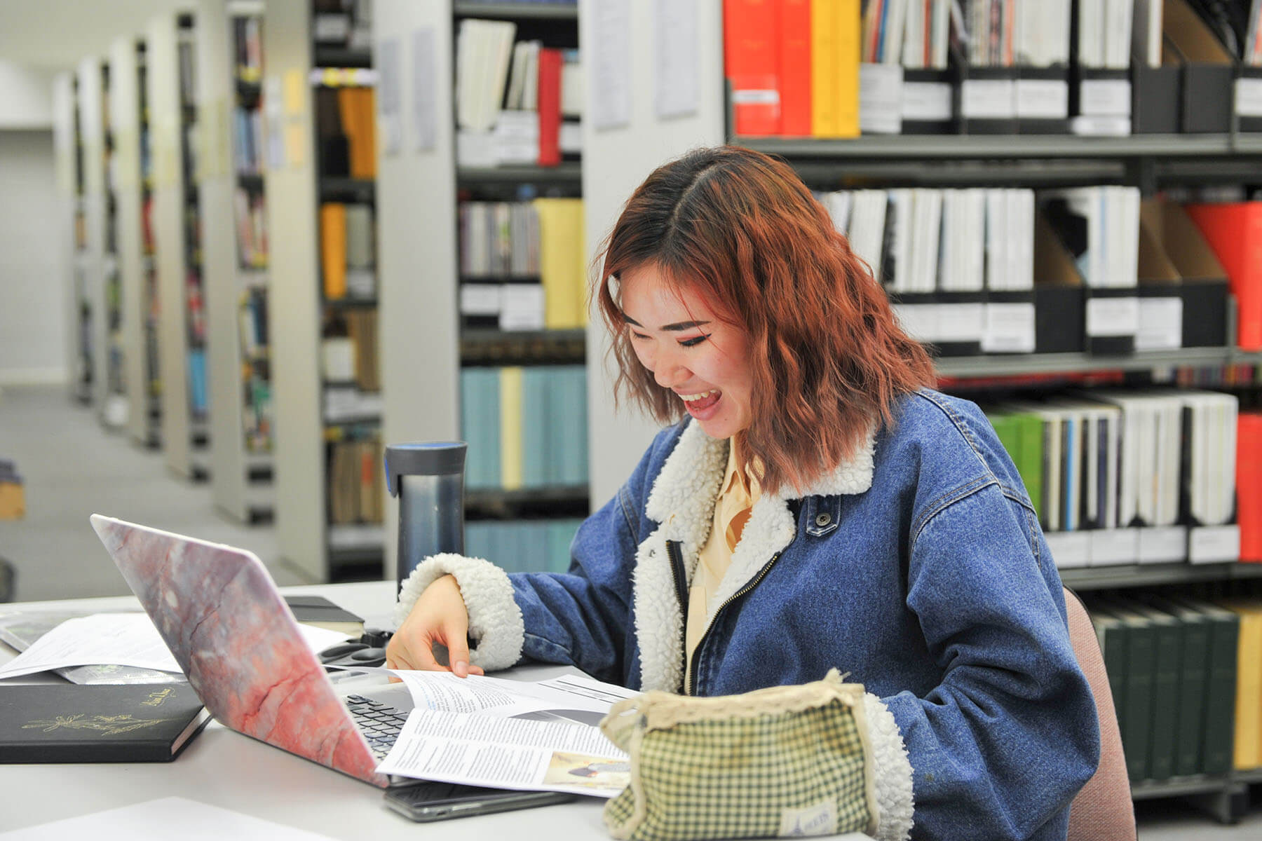 Student in library in Epsom UCA