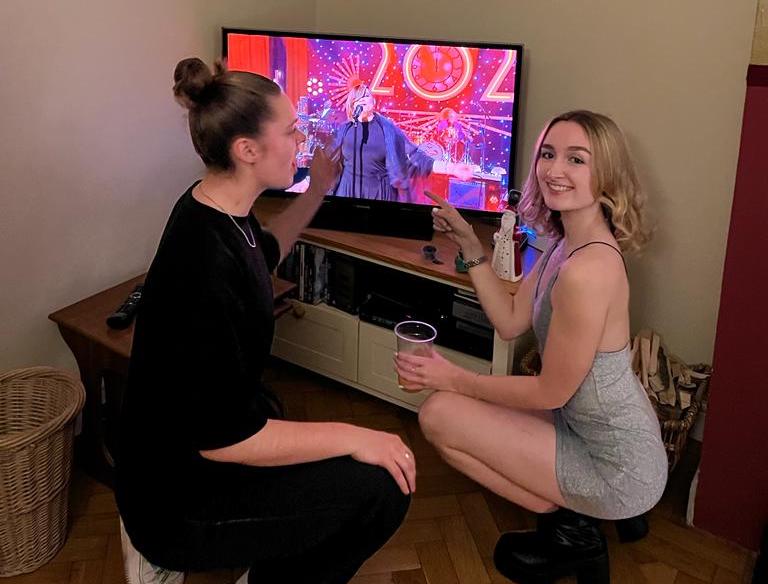 Ruby Chapman and Elsie Potter on New Year's Eve with Jools Holland's Hootenanny on the TV behind them