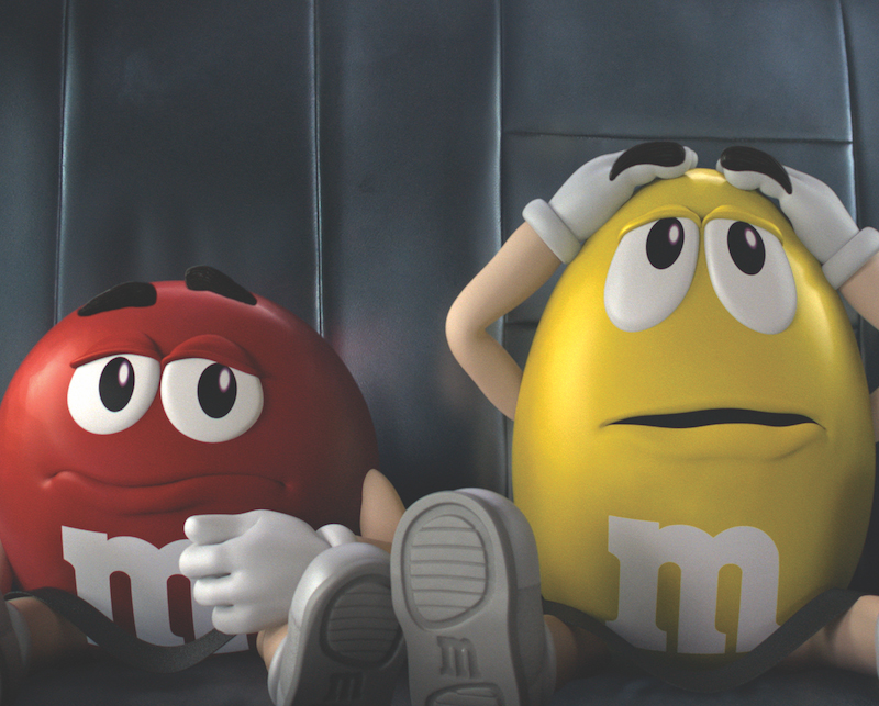 Image shows the two main M&M characters, red and yellow, from a commercial designed by David Hulin