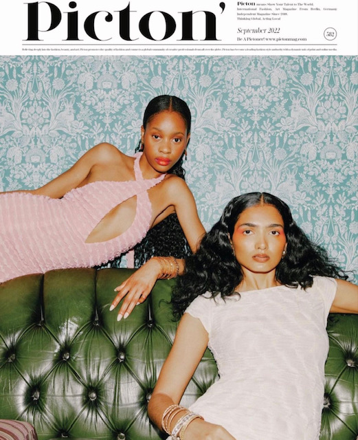 A magazine cover - Picton magazine - showing two models in pastel coloured clothing, positioned on a green leather couch
