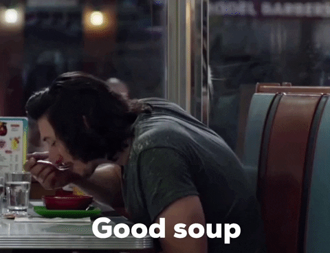 A gif image of Adam Driver eating soup and saying 