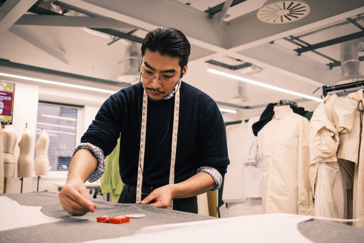 Student working on an outfit in an atelier studio