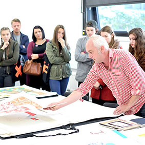 Staff and students looking at portfolios